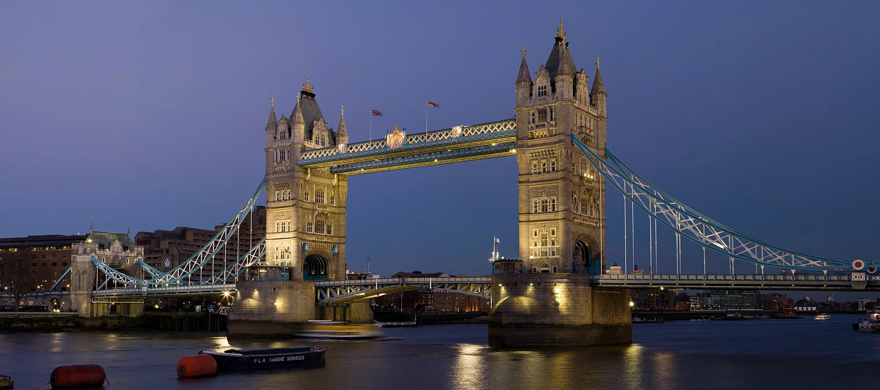 Tower Bridge illuminated at dusk over the River Thames in London